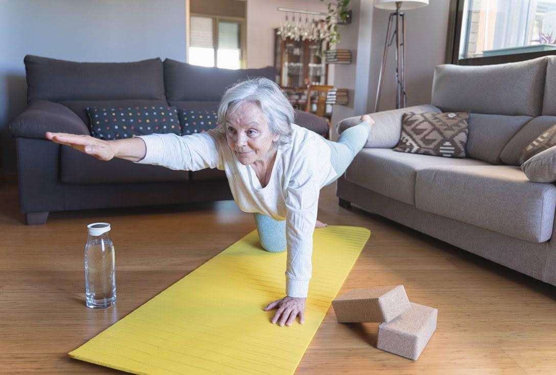 Older woman practicing yoga at home Cover Image for Post